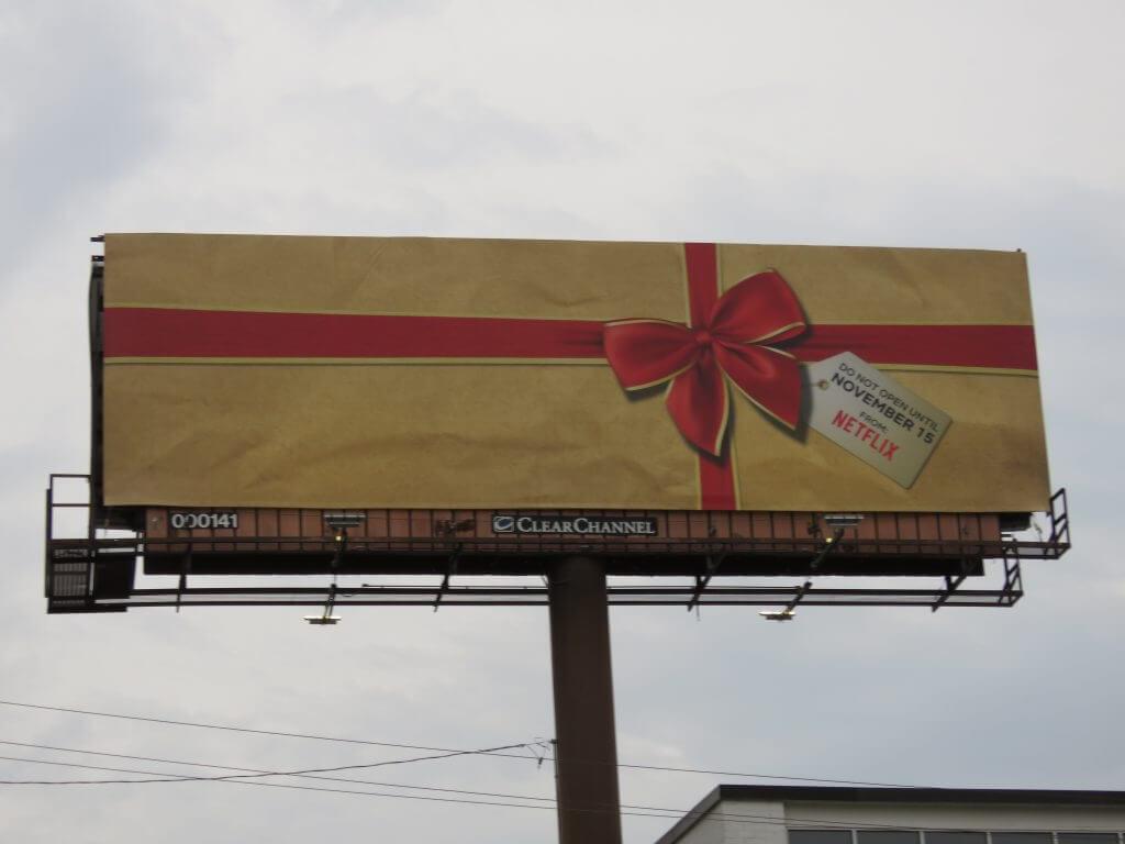 Image of billboard by Netflix of wrapped present, saying "Do not open until November 15 From Netflix"