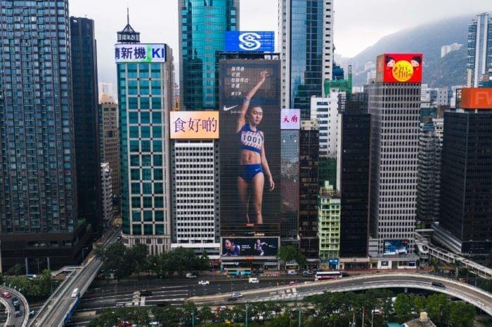An image of a large building-sized ad for Nike with Cecilia Yang on it.