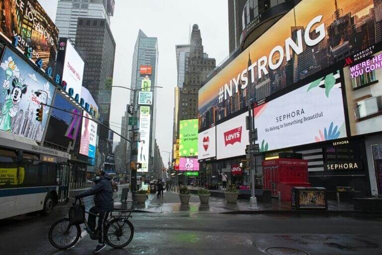 Image of street of New York with billboard advertisements. One billboard ad reads, "#NYSTRONG" 