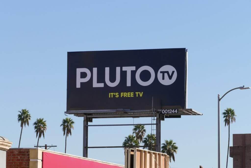 Image of billboard advertising Pluto TV. Ad says, "Pluto TV It's free TV"
