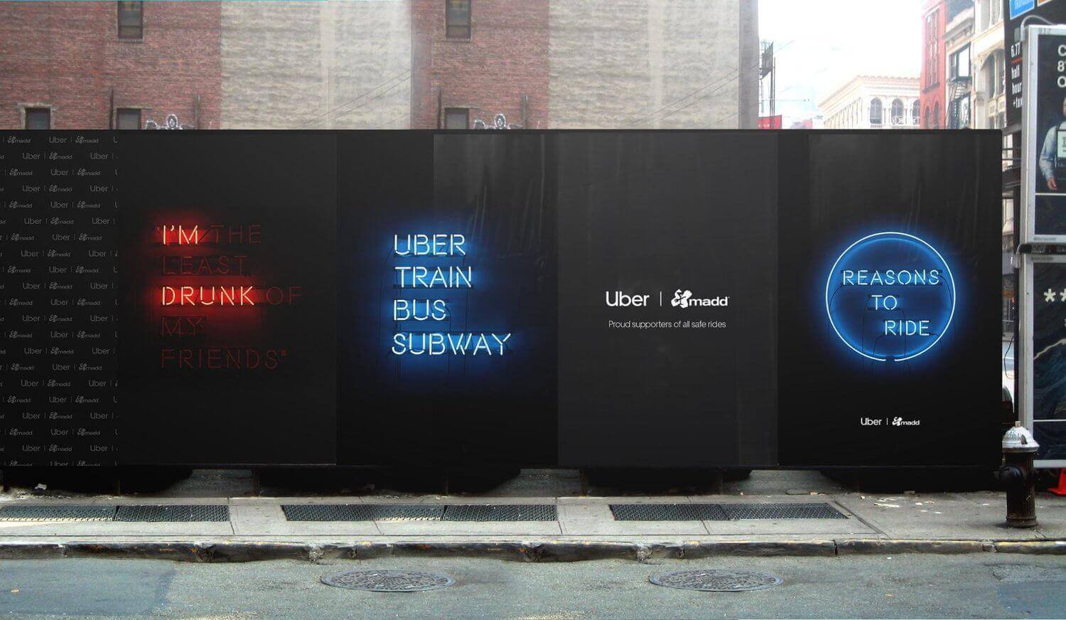 An image of the side of a building that displays an ad for Uber. In florescent blue and red the ad talks about the different options for transportation when drunk and why to ride with Uber instead of driving.