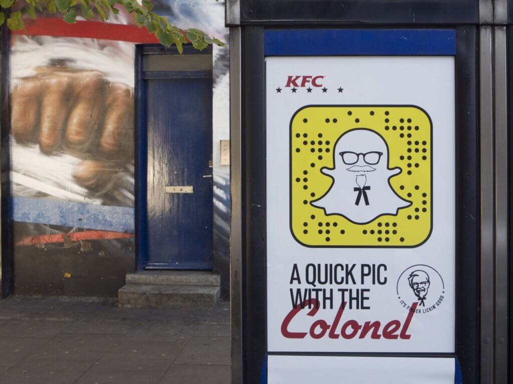 An image of a digital OOH billboard for KFC. It has a scannable code through snapchat on it.