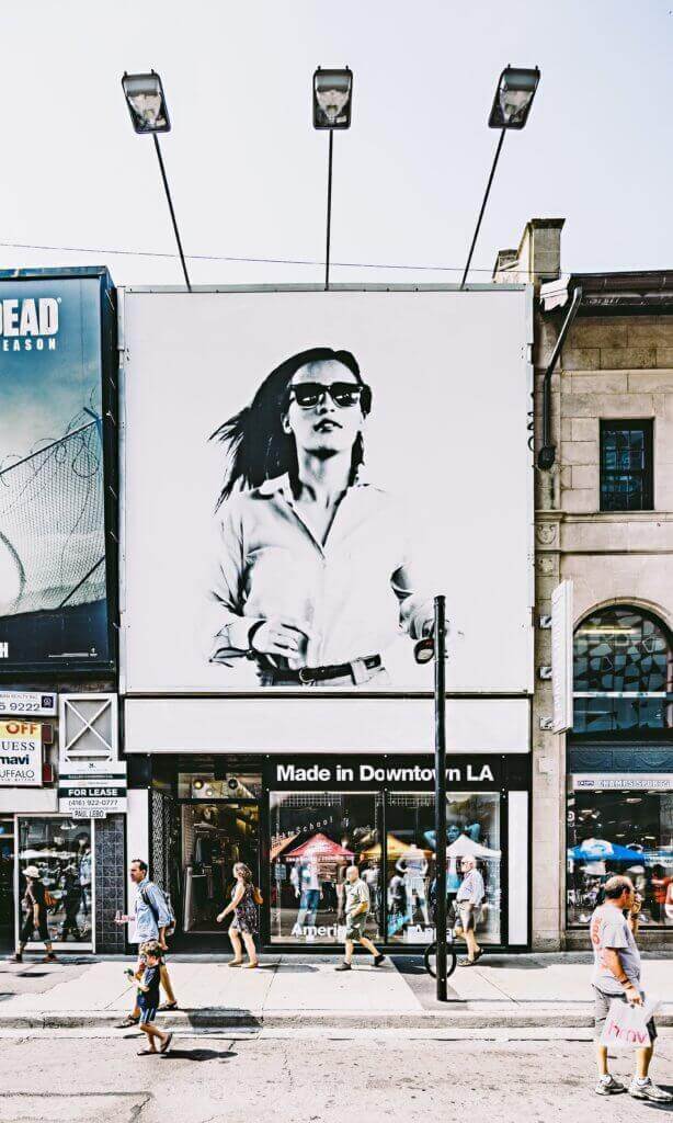 Woman with sunglasses depicted on a billboard in downtown Los Angeles.