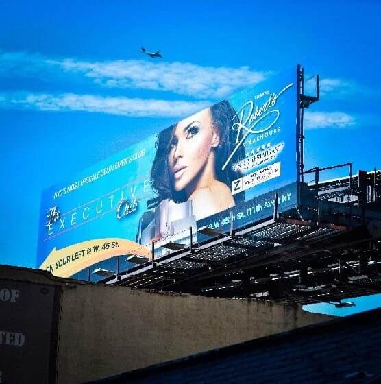 Billboard with a bright sky blue background.