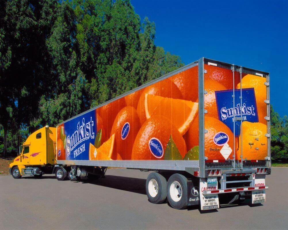 Image of truck advertising Sunkist oranges on the sides and back of the truck. 