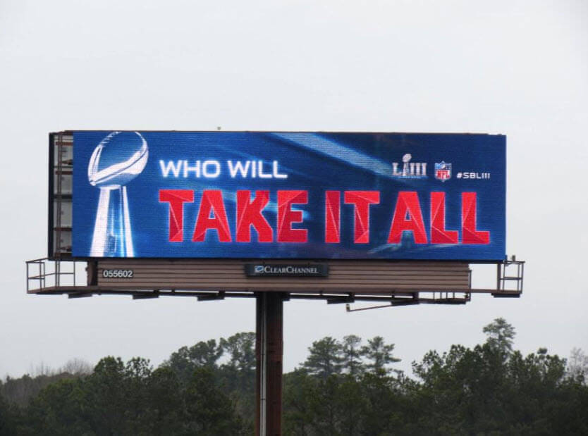 An image of a billboard with an ad for the Super Bowl.